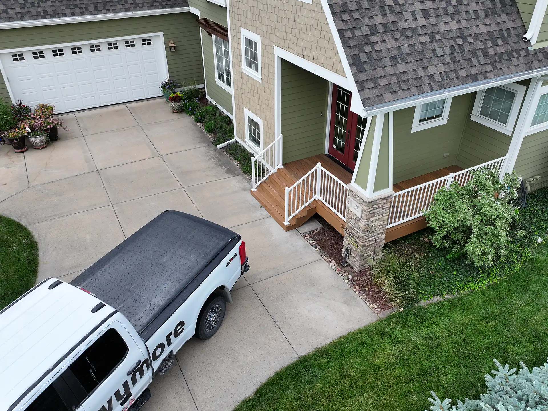 Photo of a covered porch with a small wraparound deck in Bellevue, NE