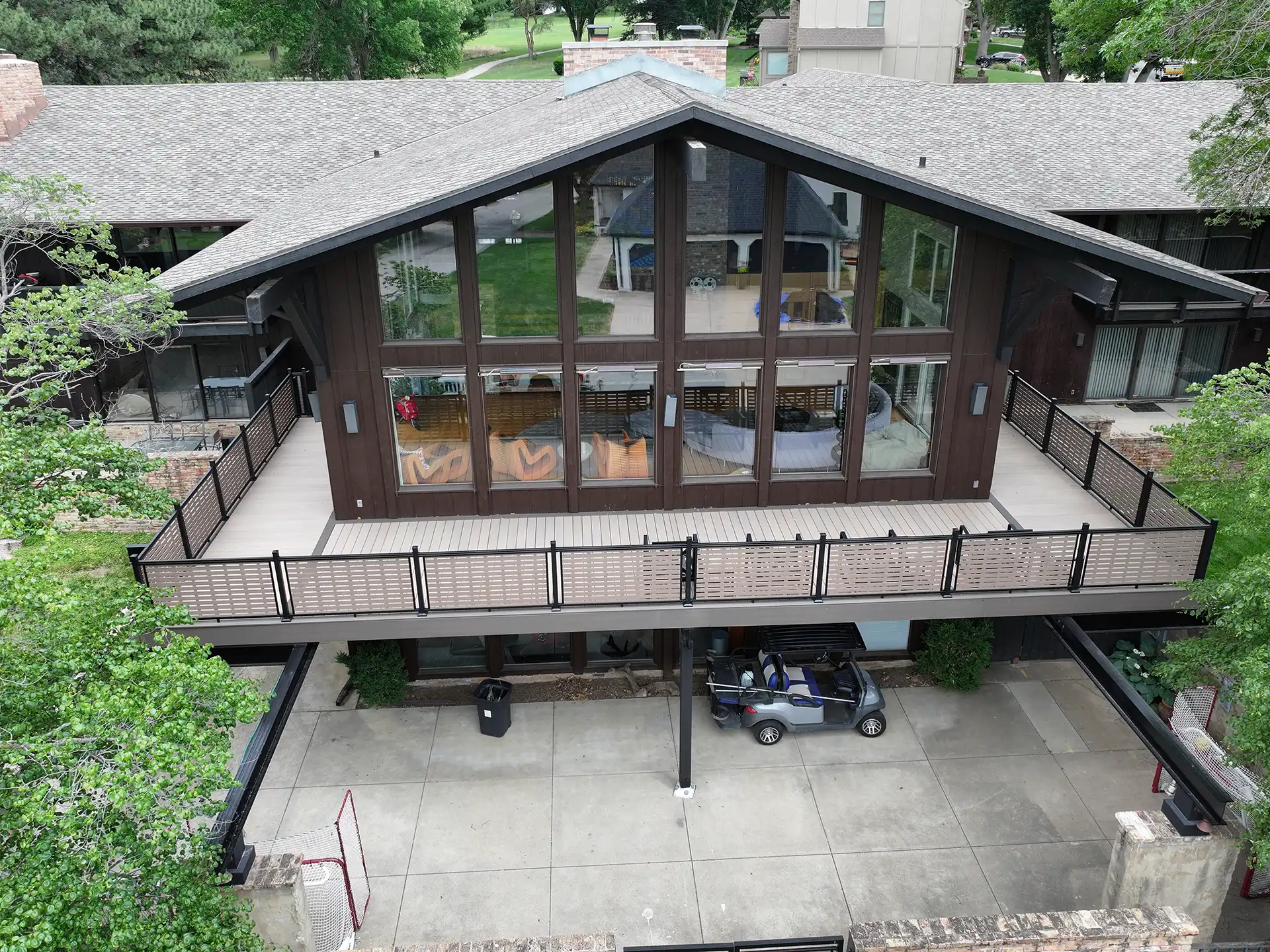 Photo of a custom deck that is a wraparound deck with a patio underneath.