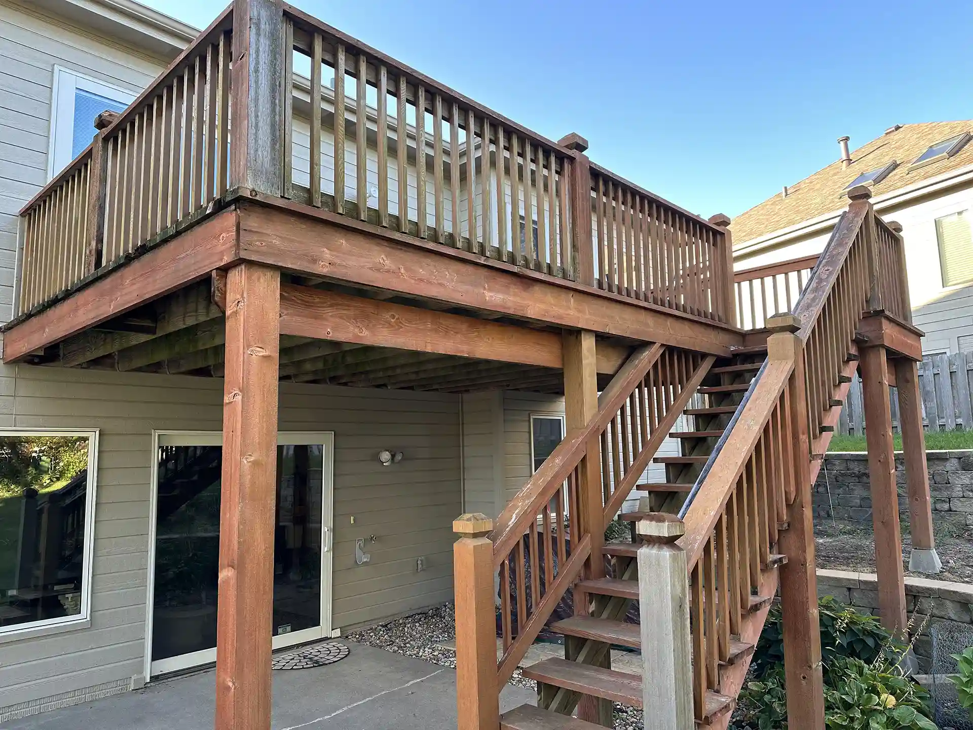 photo of an elevated wooden deck with boards that are worn