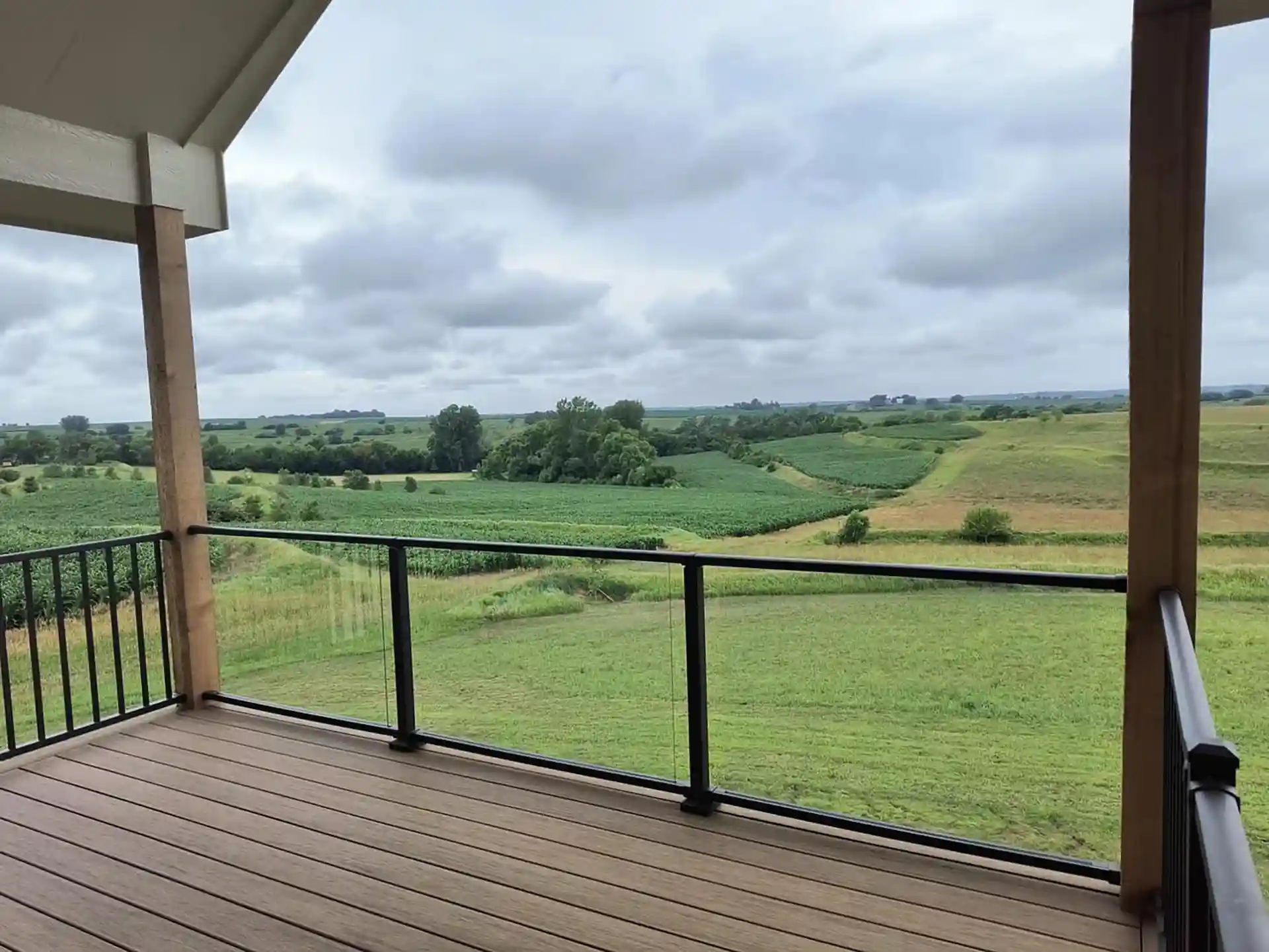 photo of an elevated covered deck with glass panels as part of the