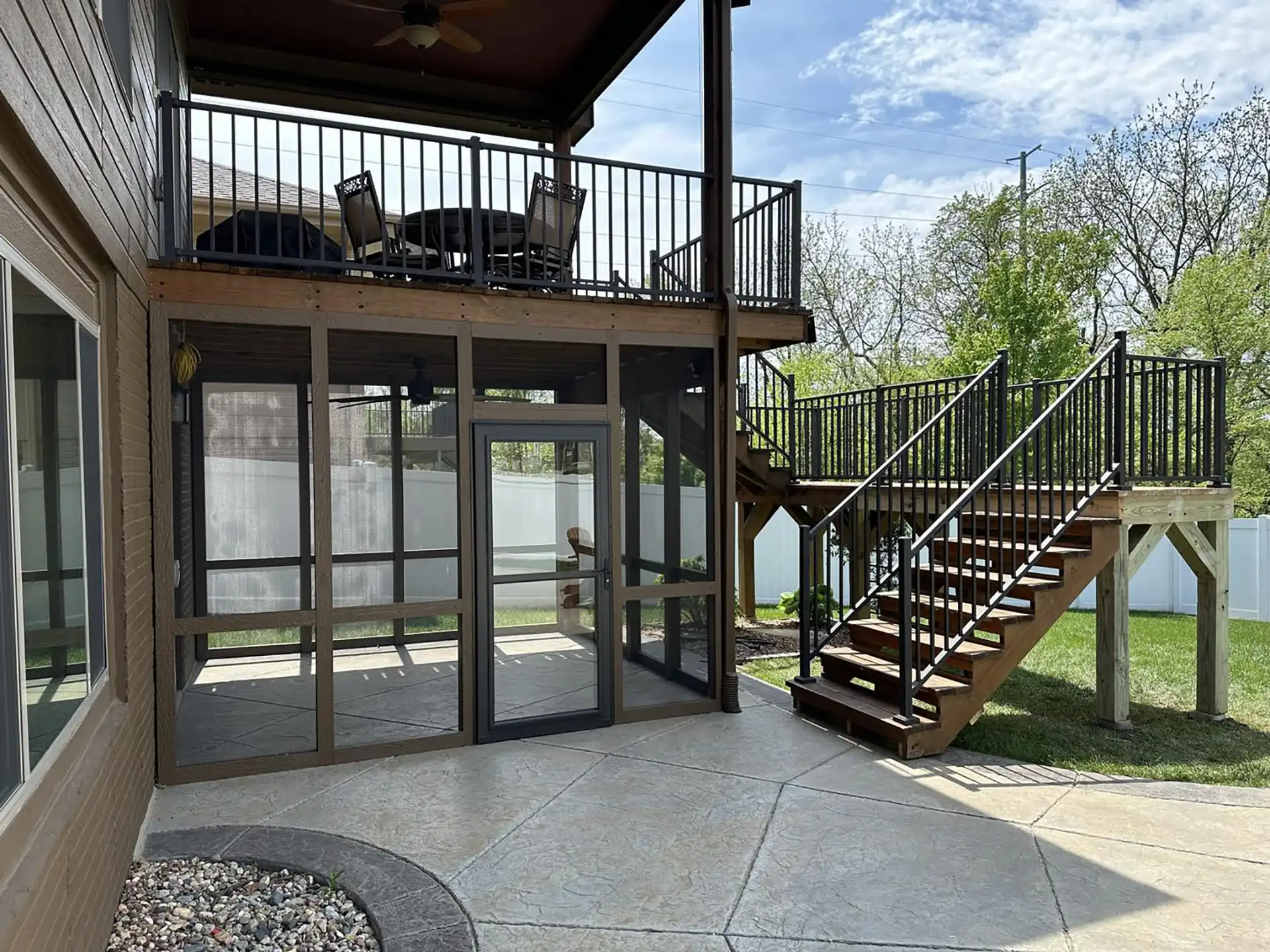 Photo of a screen room, multi-level deck, and patio