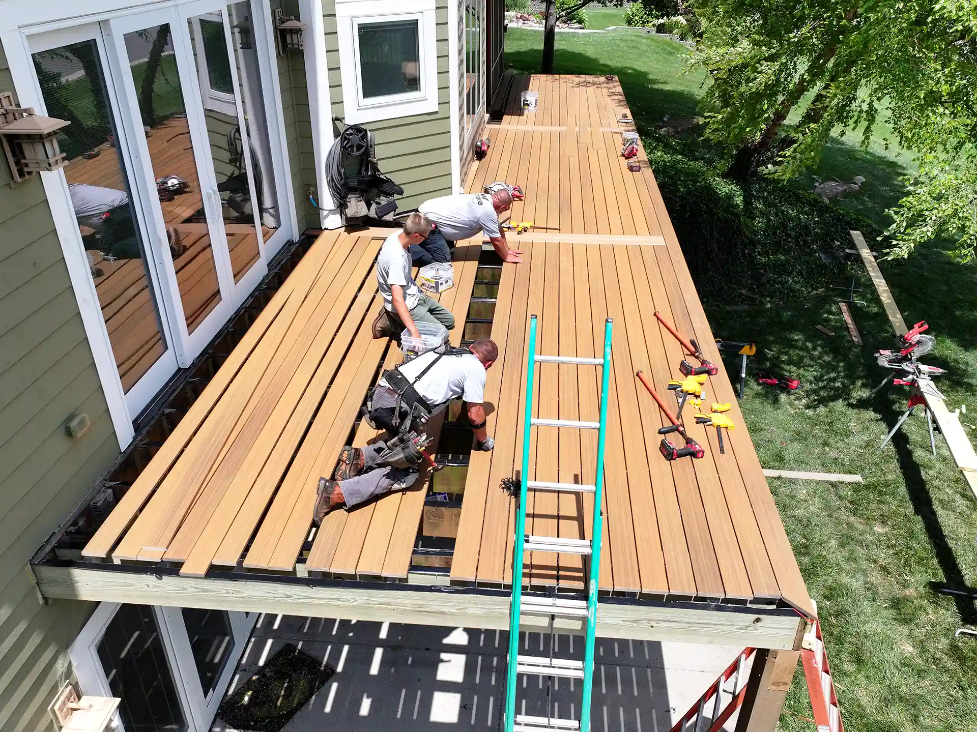 Crew building an elevated deck - Mistakes-to-Avoid-When-Choosing-a-Deck-Builder - cost to build deck omaha​