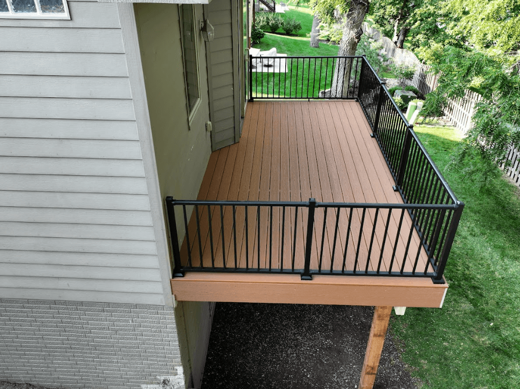 Photo of a new, elevated composite deck with black metal railings