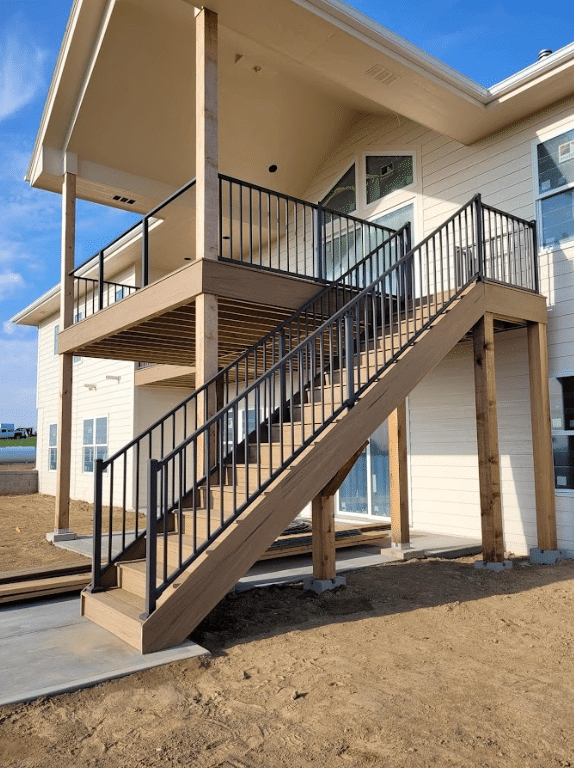 photo-of-an-elevated-covered-deck-with-deck-railing-glass-panels-and-steps-leading-to-deck - Custom Decks with glass railings ideas