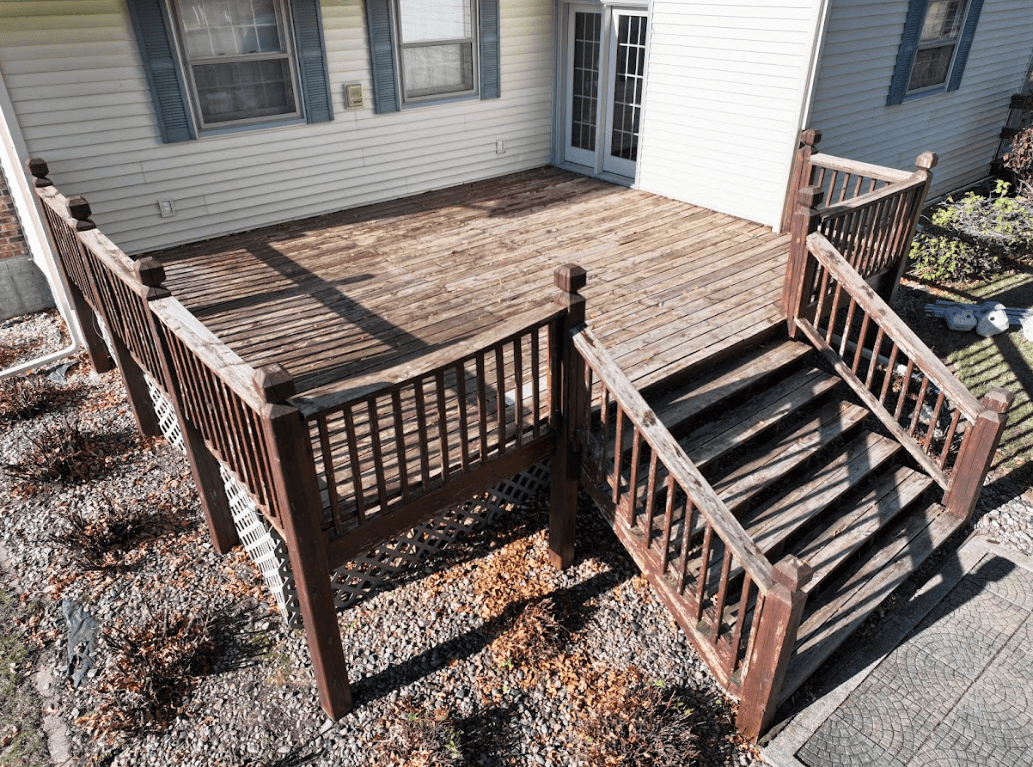 photo of an old, worn out deck with chipped paint that needs to be replaced